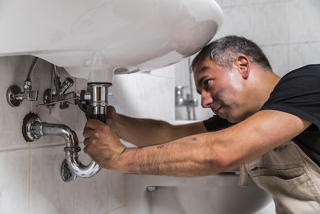 A plumber fixing an issue