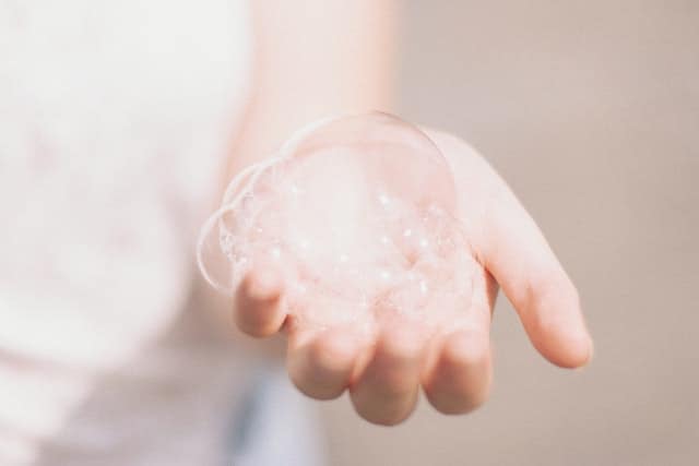 A soap bubble in someones hand