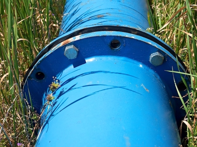 Repaired water pipes with blue flanges and screws