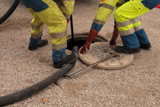 Two plumbers performing Sewer cleaning