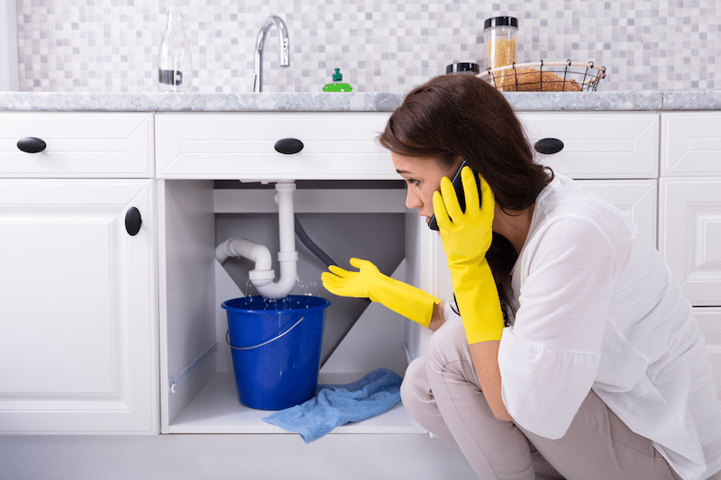 A woman experiencing plumbing problems