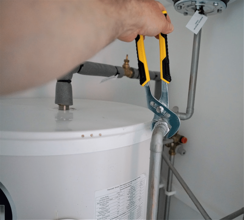 A plumber fixing a heater 