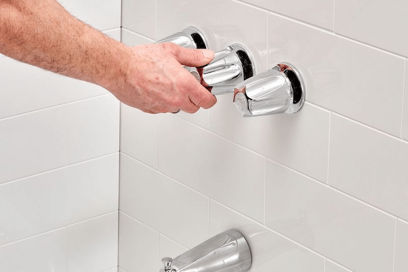 A plumber fixing a faucet