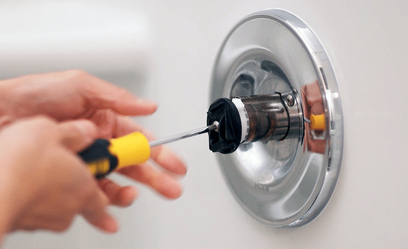 A plumber fixing a faucet 