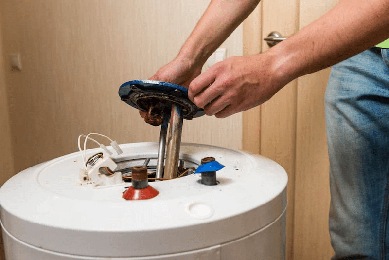 A plumber fixing a water heater