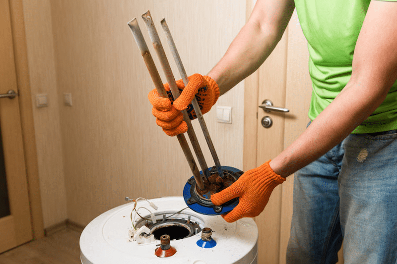 A plumber fixing a water heater