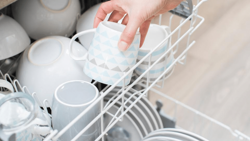 A person putting dishes in the dishwasher 