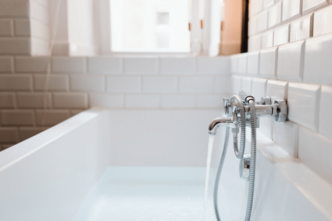 A running faucet in a bath tub 