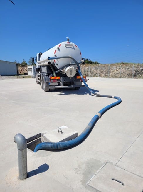 A trailer draining a septic tank 