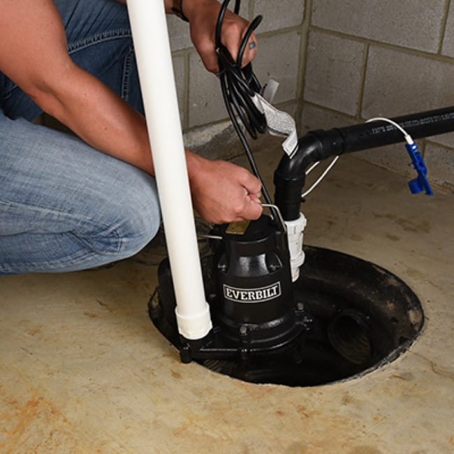 Plumber fixing a sump pump