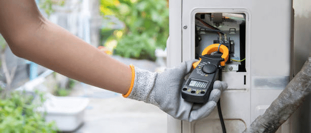 A plumber testing components of a water heater