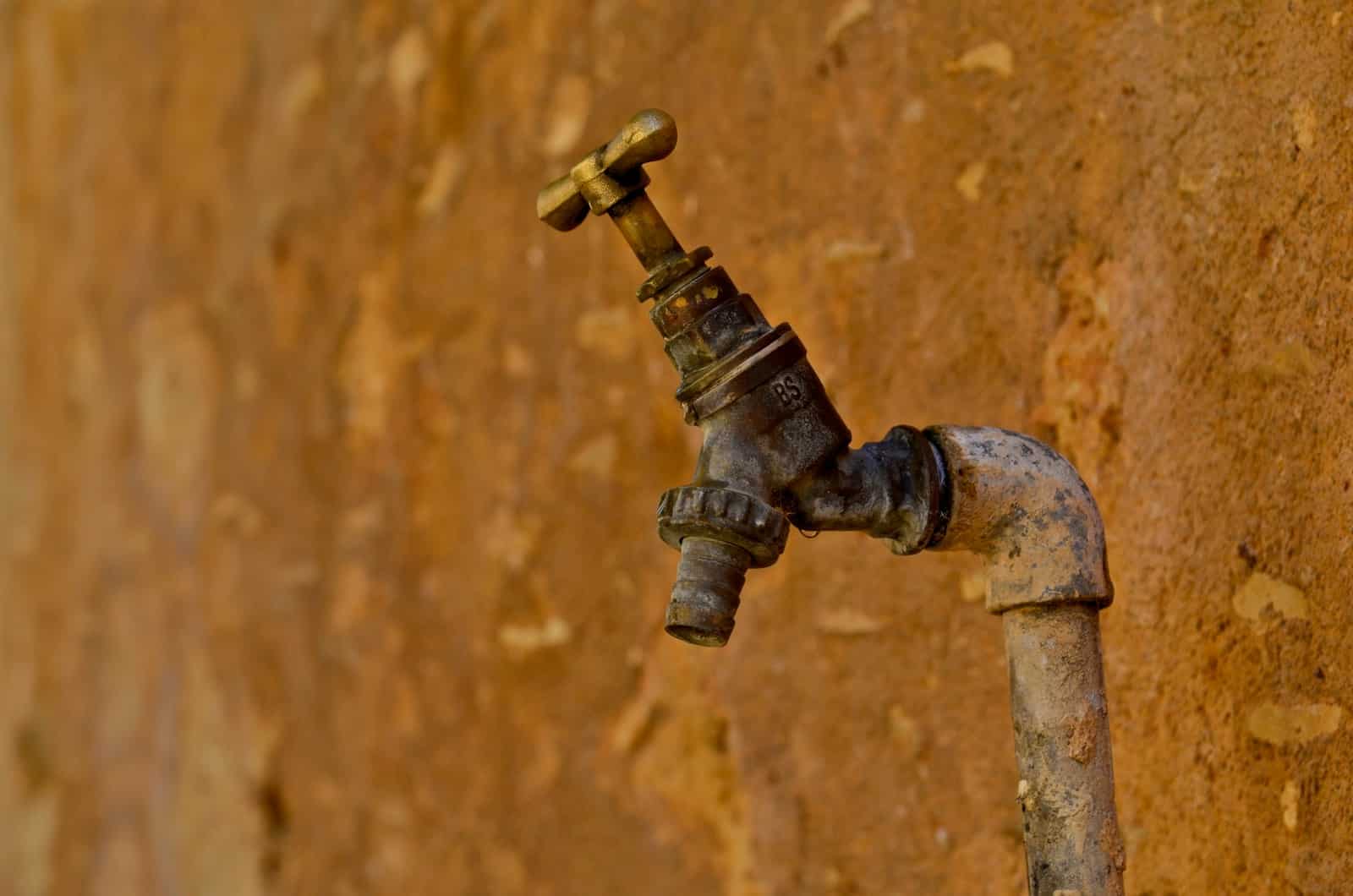 selective focus photography of brown faucet how to fix a leaky outdoor faucet