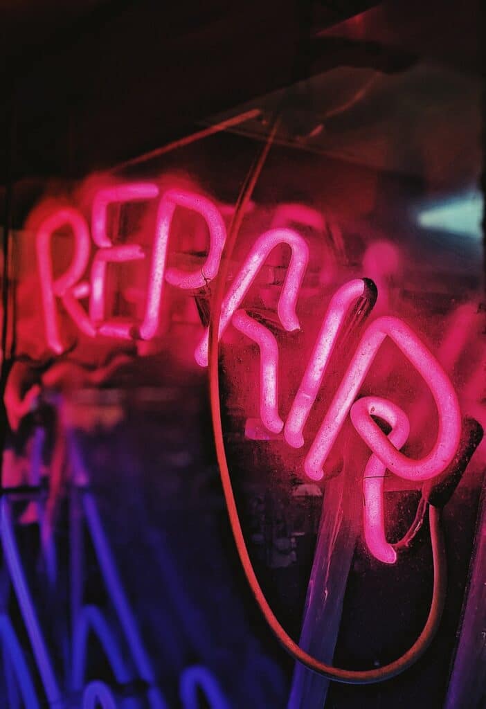 red and blue repair neon light signage close-up photo