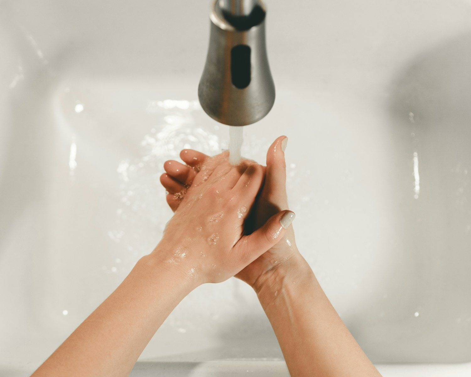 persons feet on white bathtub ways to conserve water