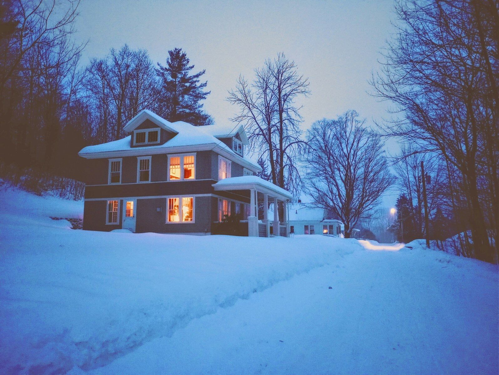 Cozy house surrounded by snow in winter season.