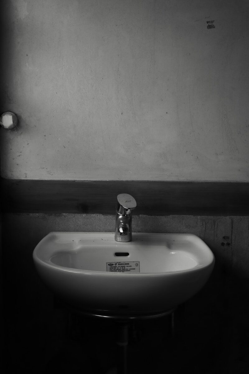 white ceramic sink with stainless steel faucet