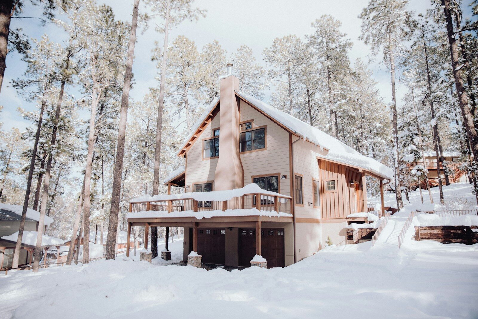 Photo by Bailey Alexander a house in the woods covered in snow