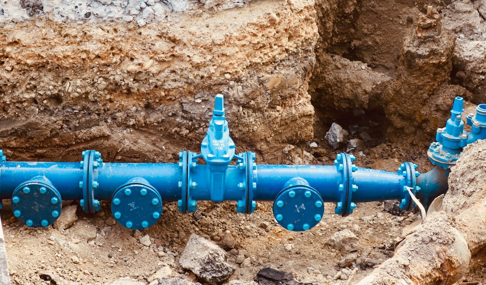 Photo by Rose Galloway Green a blue pipe laying on top of a pile of dirt