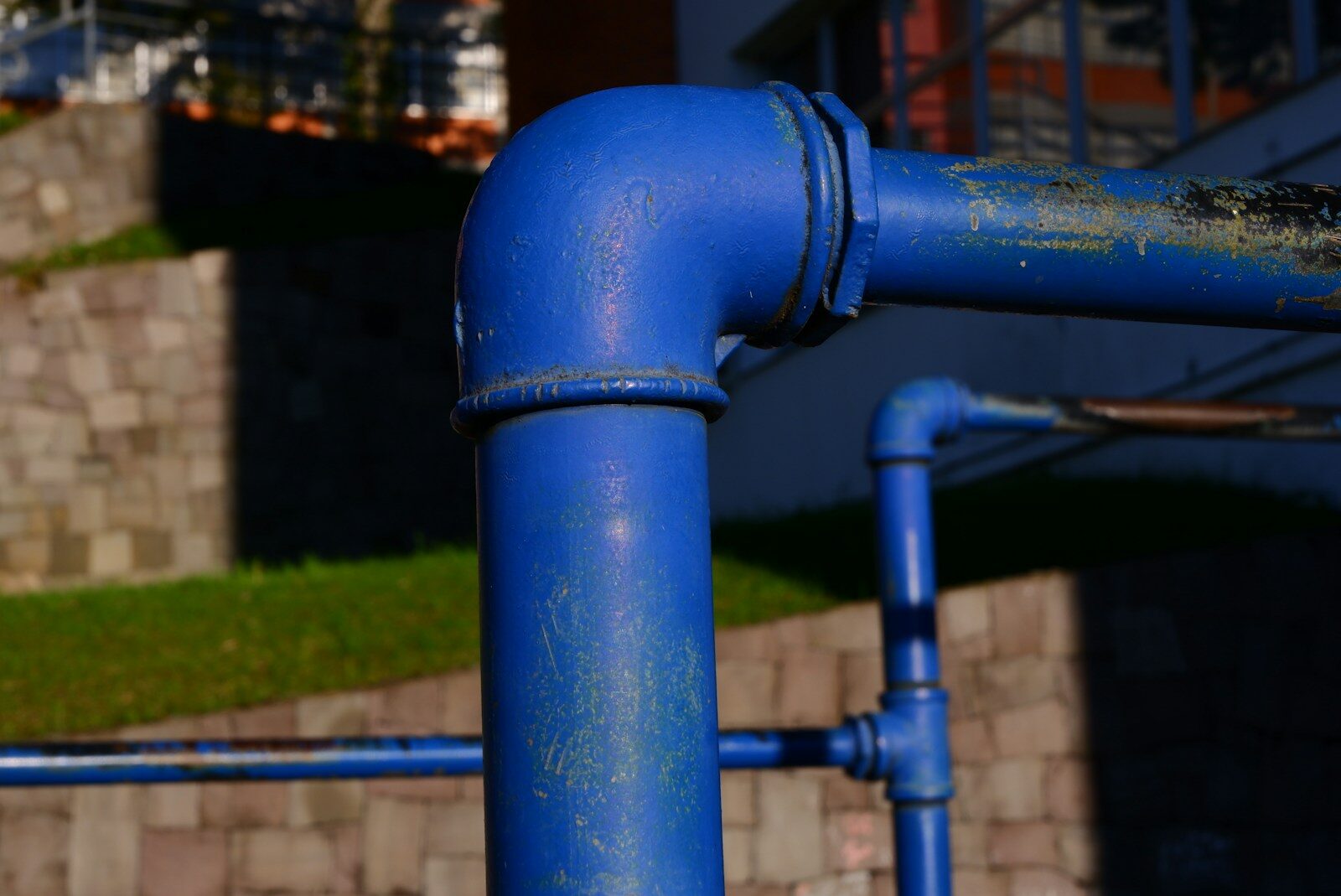 A blue pipe on the side of a building
