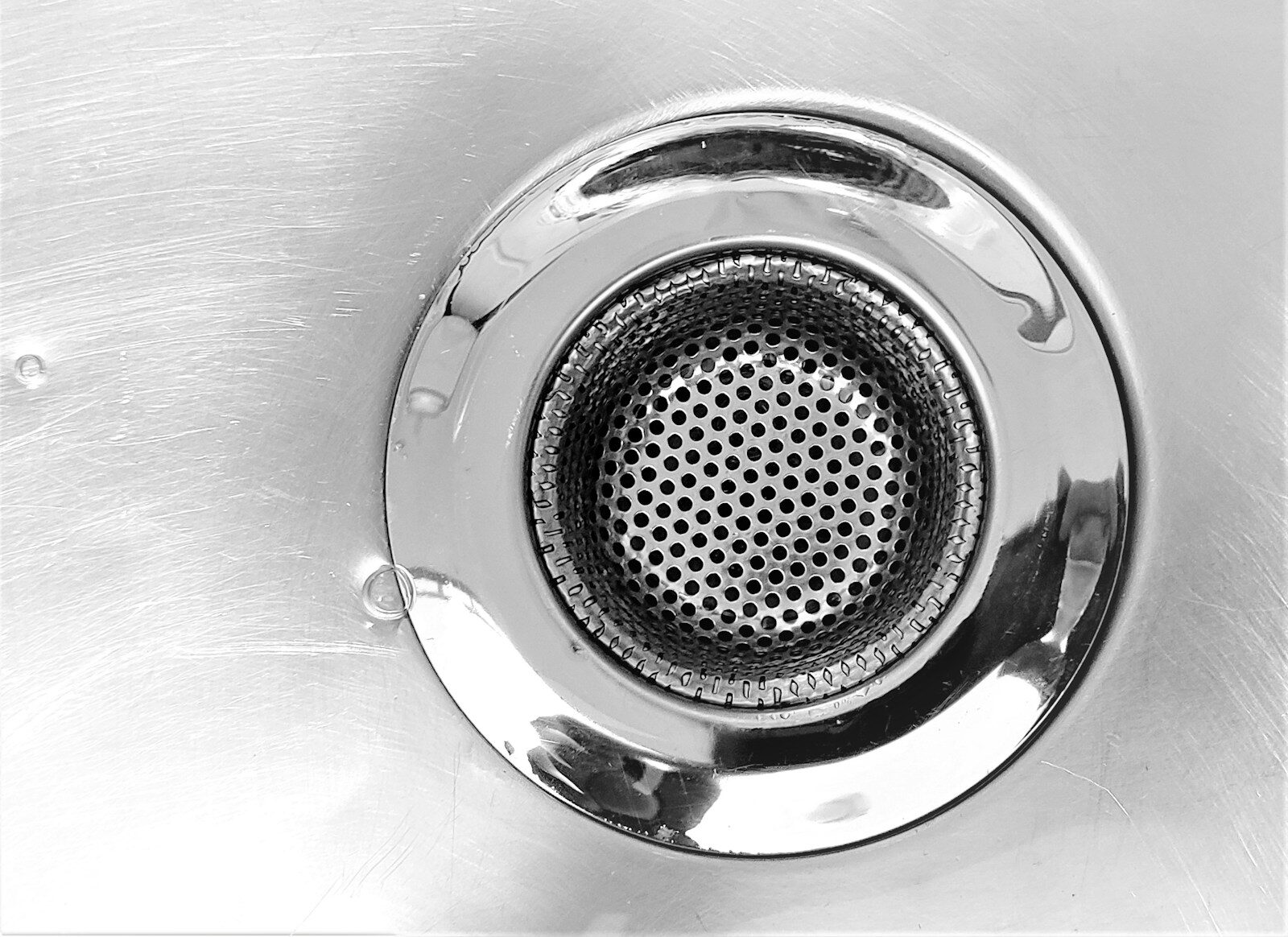 a close up of a metal sink drain What Are Drain Worms and How Do You Get Rid of Them?