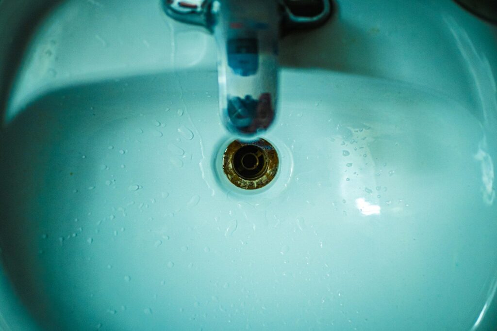 a close up of a sink with water droplets
