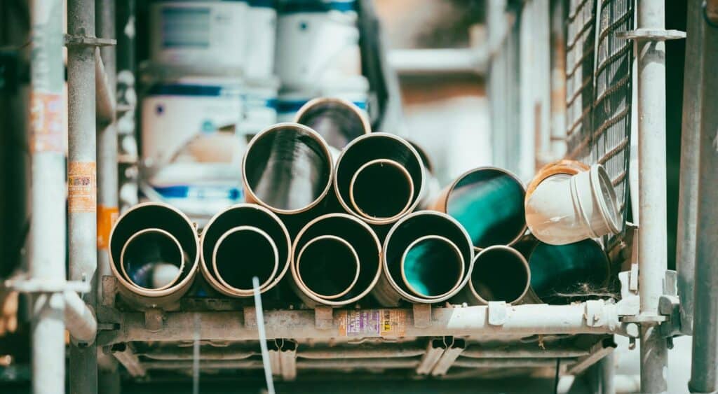 A stack of cylindrical pipes on a metal construction scaffold